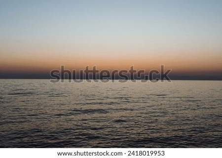 beautiful evening landscape on the sea. sunset of the setting sun. the sun disappeared behind the horizon of the sea. calm, calm sea at sunset