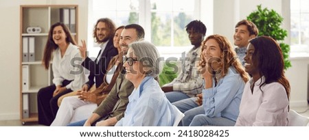 Candid happy diverse young senior female male businesspeople entrepreneur colleague audience at business forum event staff training listen to speech by successful coach making funny good humor jokes Royalty-Free Stock Photo #2418028425