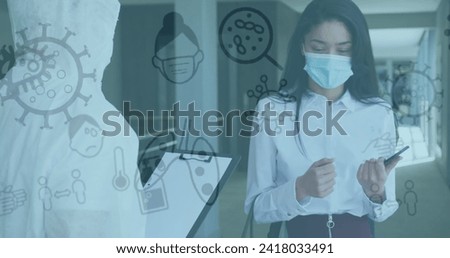Image of covid-19 icons floating with colleagues in office wearing face masks. Healthcare and protection during coronavirus covid 19 pandemic, digitally generated image