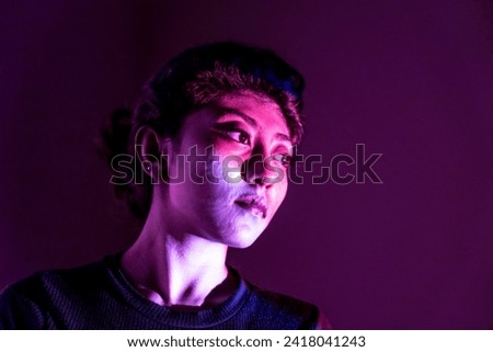 close-up look of a multiracial girl on the side angle with the multiple different light falling in our face with a huge empty space