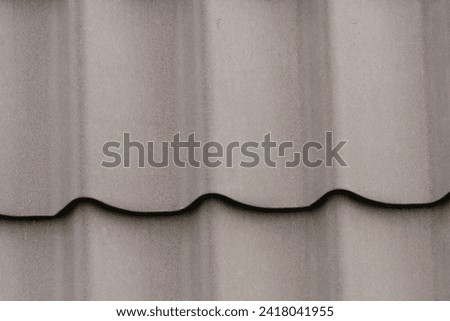 It is close up view of grey roof tiles. It is  view of light gray roof tile. It is view of a tile texture.