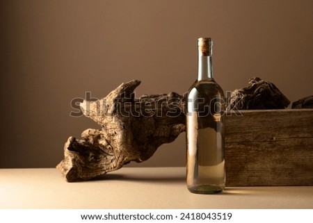 White wine and old snag on a beige background. Copy space.