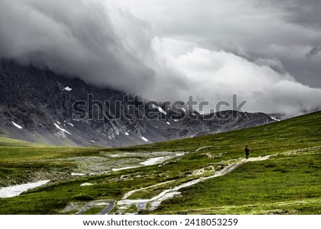 Beautiful dark mountains in Norway among the clouds. Trekanten (Triangle Route) in Trollheimen.