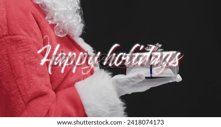 Happy holidays text over father christmas holding present on black background. Christmas, tradition, greetings and celebration digitally generated image.