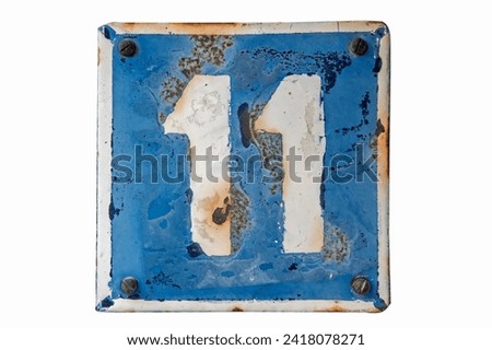 Weathered grunge square metal enameled plate of number of street address with number 11 isolated on white background
