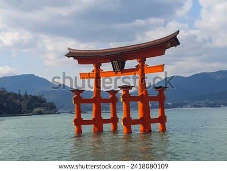 Floating gate (Giant Torii) of Itsukushima Shrine in Hiroshima, Japan. This historic temple complex is listed as a UNESCO World Heritage Site and is a photo object for tourists who come to Hiroshima.