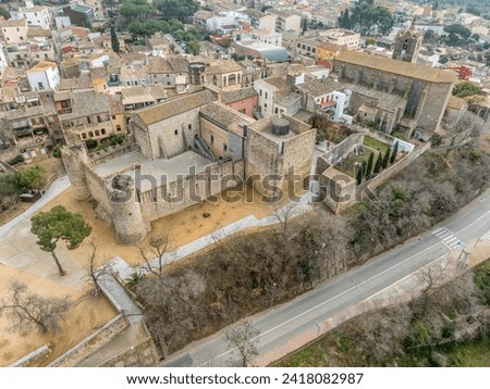 Aerial view of Calonge town medieval castle with inner garrison courtyard surrounded by walls with crenallations and quare old tower, residential palace. Venue for music festival in Catalonia Spain