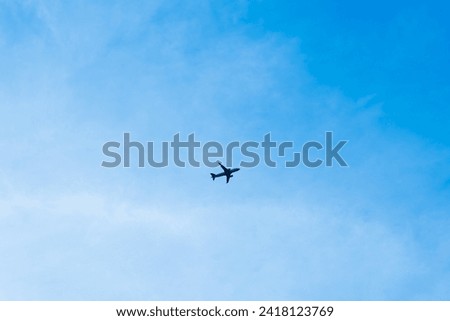 Airplanes soar through the blue sky in formation, navigating the clouds alongside birds, embodying the freedom of flight in nature's vast expanse