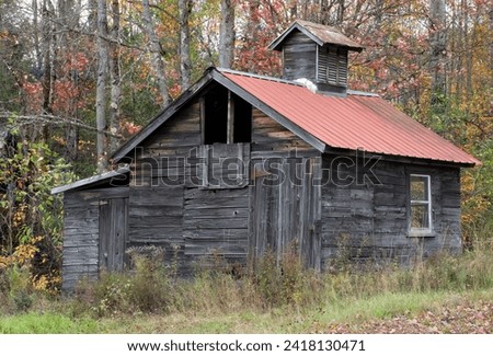 Autumn scene in New England. Old abandoned and weathered maple syrup sugar shack in rural Sugar Hill, New Hampshire Royalty-Free Stock Photo #2418130471