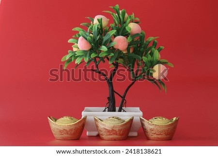 Figure of Plum tree and Yuan Bao Gold , red background for offering to God in Chinese's belief for Purity and wealth