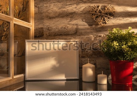 Empty photo frame on a kitchen worktop in a Provencal house with sunlight. Shadow of daylight through the window.