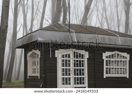 Cute wooden hutch at the riverside, foggy scenery. 