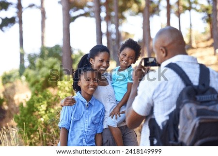 Happy black family, photographer and nature for hiking, bonding or outdoor together for photo. African mother, children and father smile taking picture on phone for photography or adventure in nature