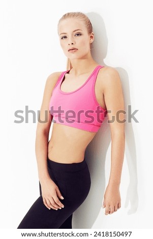 Portrait, fitness or body of young woman in studio isolated on a white background. Health, serious person exercise or confident blonde model training in sportswear for physical workout in Switzerland