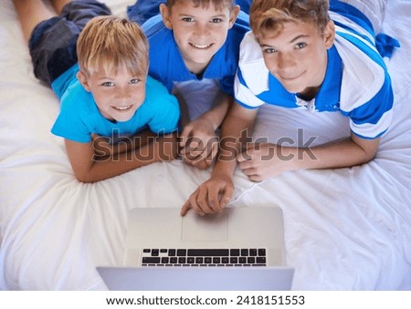 Brothers, home and playing on laptop in bedroom, above and excited for online games in house. Young children, mousepad and streaming cartoons on bed for bonding together, love and relax on weekend