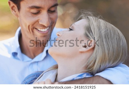 Happy couple, closeup and hug in nature for embrace, love or support in relax for outdoor bonding. Face of young woman and man with smile for affection, comfort or romance in forest or woods together