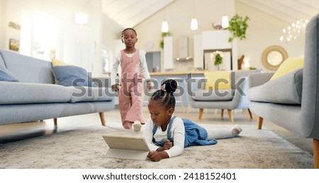 Black girl children on ground with tablet and relax, elearning or watch cartoon movie, sisters at home and screen time. Young female kids, streaming online and subscription to education app or film