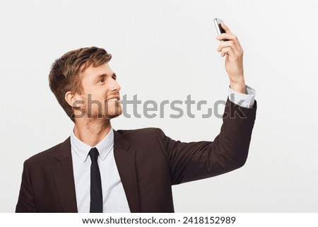 Phone, smile and selfie with a business man in studio on a white background for communication. Mobile, happy and reception with a confident young employee in a suit to search for network connection