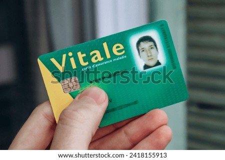 Young man's health insurance card of the national health care system in France, named Carte Vitale (translation "Vital card") Royalty-Free Stock Photo #2418155913