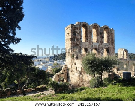 A part view of the Odeon of Herodes Atticus, as viewed from the path leading up to the slope of the Acropolis hill. Royalty-Free Stock Photo #2418157167