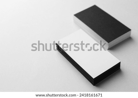 Blank black and white business cards on light background. Mockup for design