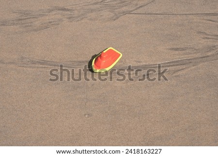 children's toy boat on the beach
