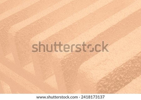 Abstract architecture background. Light orange modern concrete structure building detail. Crossing lines. Geometric shapes. vintage colors style or look. old, classical architectural photography
