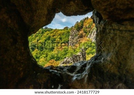 natural window in a cave overlooking the mountain slope of the Western Caucasus (South Russia)