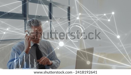 Image of statistics and data processing over caucasian businessman using laptop in office. Global business, connections, computing and data processing concept digitally generated image.