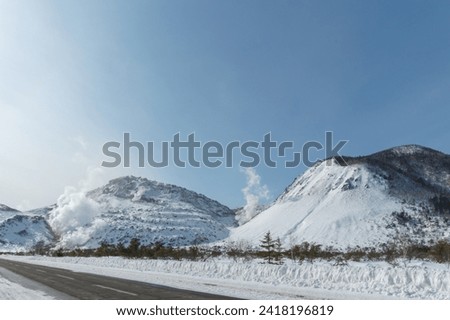 Abandoned sulphur mine and steaming crater of Mt. Io volcano winter landscape