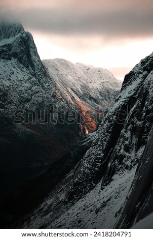 Sunrise on snowy mountains in Senja, Norway Royalty-Free Stock Photo #2418204791