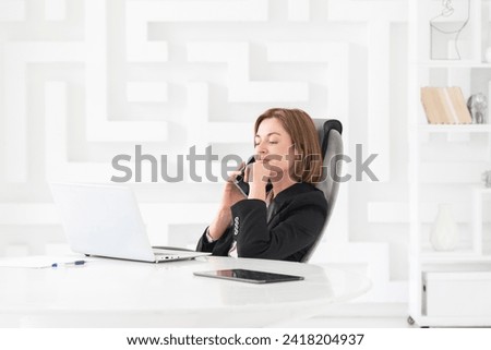 Attractive business woman in black suit working in modern office	