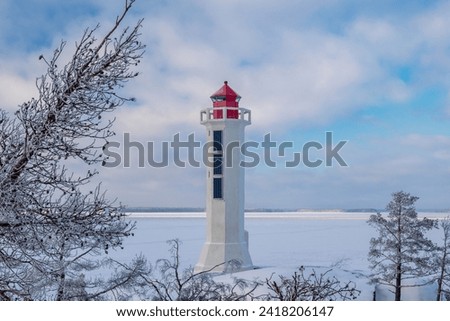 Winter Finnish lighthouse Kuninkaansaari (Povorotny), Vikhrevoy Island, Vyborg Bay, Gulf of Finland, Russia Royalty-Free Stock Photo #2418206147