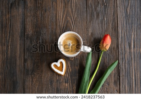 Fresh orange tulips and cappuccino mug with spring composition. Greeting card with copy space for Valentine's Day, Woman's Day and Mother's Day.