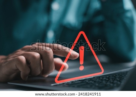 Businessman use laptop with virtual warning sign for caution in investing economic situation warning, Business investment risks. Royalty-Free Stock Photo #2418241911