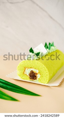 Pandan flavored roll cake with gula melaka and cheese cream inside 