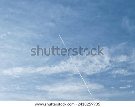 Flying jet over on the Cloudy Sky background, Flying aero plane with smoke behind it Royalty-Free Stock Photo #2418259905
