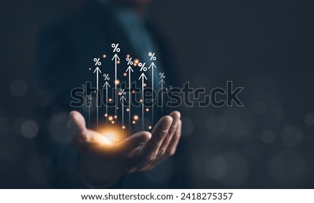 Interest rate and dividend concept. Businessman hand with rising arrow and percentage icon. Business finance and money concept, Investment growth, Return on stock, mutual fund, Increase profitability. Royalty-Free Stock Photo #2418275357