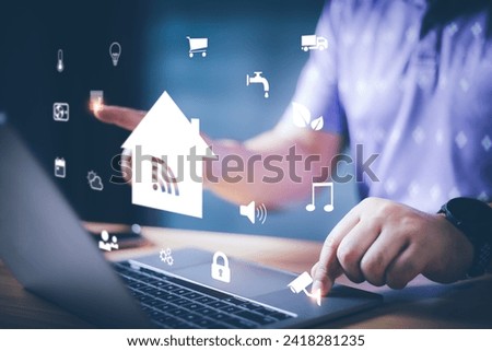 Businessman using smart home control app on laptop with augmented reality view of IOT connected objects in apartment, Smart home concept. Remote control and home management.