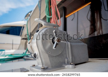 Motor yacht moored for repairs and service in dry dock Royalty-Free Stock Photo #2418299765