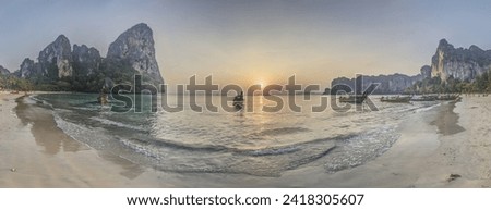 Panoramic picture of the sunset over Phang Nga Bay in Thailand with boats in the foreground