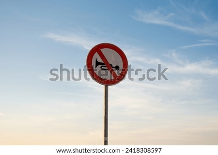 No audible warning devices traffic sign, isolated sunset sky.