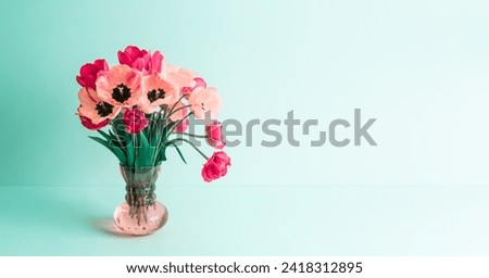 Big flowers bouquet of pink tulips in vintage glass vase on green background. Copy space. Business card. Invitation postcard. International women's day holiday card. Banner with greeting text place.