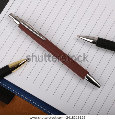 Colorful leather pen. Concept shot, top view, different colors pens. Blank space for text. Hold pen woman hand. Special background pen view