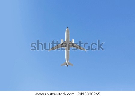 Bottom View of the Airplane in the sky with blank copy space for travel concept Royalty-Free Stock Photo #2418320965