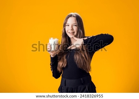 Child girl holding glass of milk. Nutrition and health concept