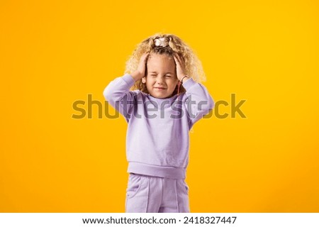 Portrait of Stressed child girl holding her head. Negative emotions concept Royalty-Free Stock Photo #2418327447