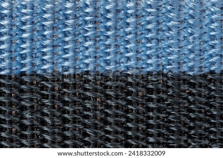 Close up texture of blue and black nylon fabric band. Background for designers.