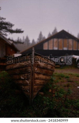 magical fairy tail dark view on a boat and house  in rainy day Norway