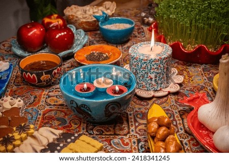 Haft Seen traditional table of Nowruz. Haft-Seen also spelled as Haft Sin is a tabletop (sofreh) arrangement of seven symbolic items traditionally displayed at Nowruz, the Iranian new year. Royalty-Free Stock Photo #2418341245